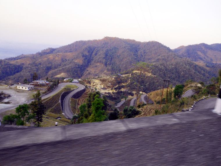 A road zig-zagging down a hillside